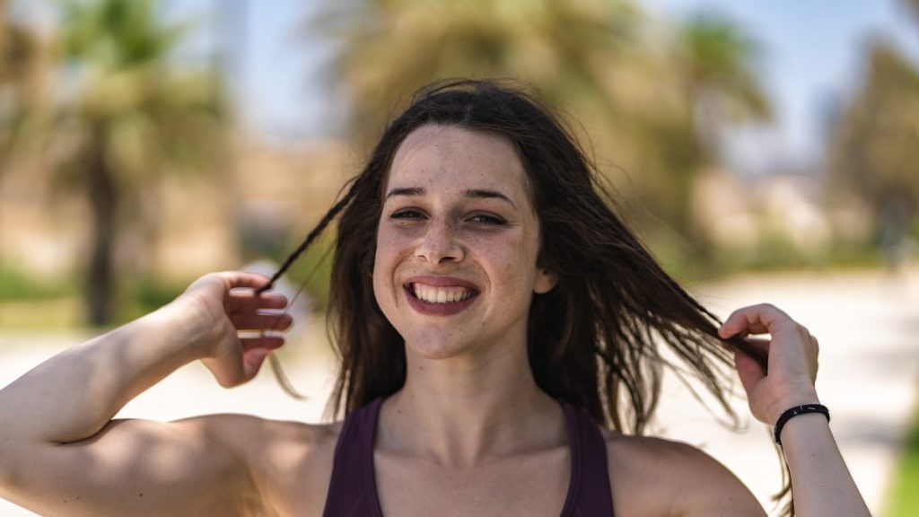 woman in black tank top smiling