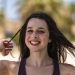 woman in black tank top smiling